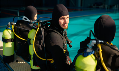 divemaster-and-two-divers-preparing-for-the-dive-2021-09-18-17-33-15-utc.webp
